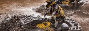 can-am outlander atv driving through deep mud